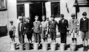 Sierpień 1944 r. Chłopcy z powstańczymi opaskami noszą wodę do szpitala na Solcu